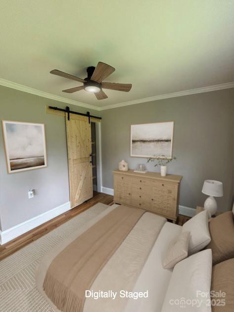 410 Gann St, Lowell, NC 28098 - bedroom with wood finished floors, ornamental molding, a barn door, and ceiling fan