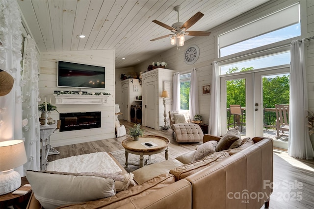 354 Ivy Ridge Cir, Sylva, NC 29779 - living room with wooden ceiling, washing machine and dryer, a glass covered fireplace, wood finished floors, and ceiling fan