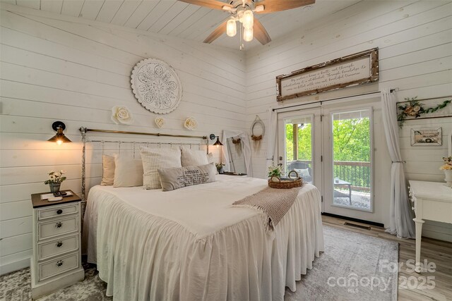 354 Ivy Ridge Cir, Sylva, NC 29779 - bedroom with wooden walls, access to outside, light wood-style flooring, and ceiling fan
