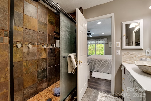354 Ivy Ridge Cir, Sylva, NC 29779 - ensuite bathroom featuring vanity, a tile shower, ceiling fan, recessed lighting, and wood finished floors