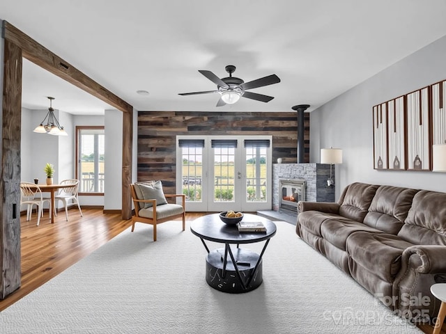 4830 Chesnee Rd, Rutherfordton, NC 28139 - living room featuring ceiling fan, wood finished floors, wood walls, and an accent wall