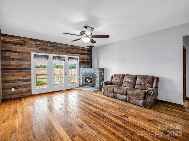 4830 Chesnee Rd, Rutherfordton, NC 28139 - living room featuring ceiling fan, wooden walls, and hardwood / wood-style floors