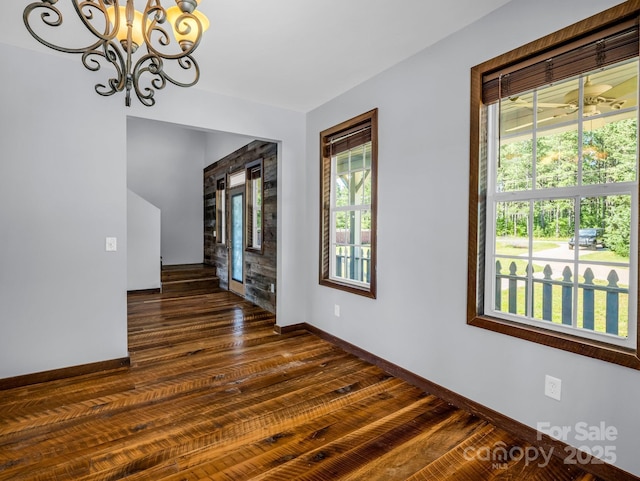 4830 Chesnee Rd, Rutherfordton, NC 28139 - spare room featuring baseboards, dark wood-style flooring, and a chandelier