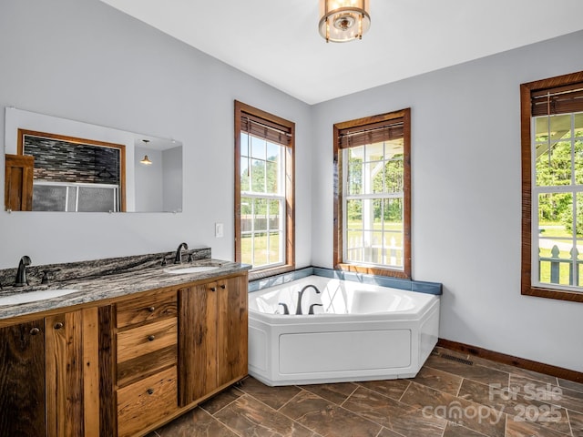 4830 Chesnee Rd, Rutherfordton, NC 28139 - full bath featuring plenty of natural light, a bath, double vanity, and baseboards