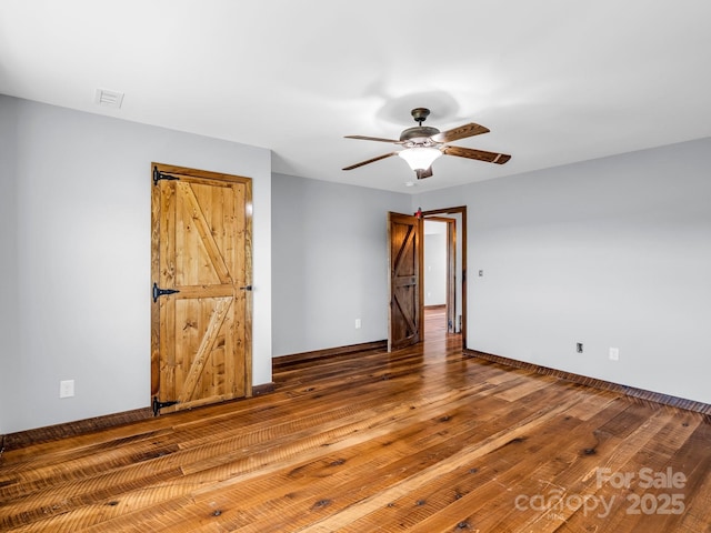 4830 Chesnee Rd, Rutherfordton, NC 28139 - unfurnished bedroom with wood-type flooring, baseboards, and ceiling fan