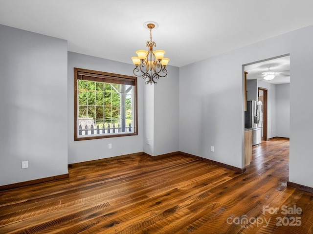 4830 Chesnee Rd, Rutherfordton, NC 28139 - spare room with a chandelier, dark wood finished floors, and baseboards