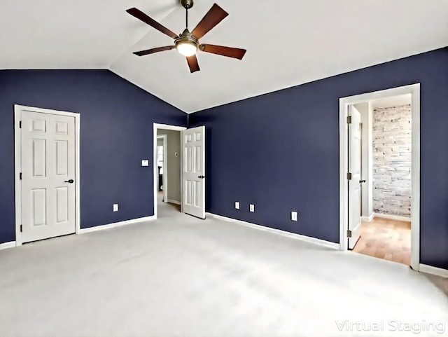 725 Center St, Asheville, NC 28803 - unfurnished bedroom with vaulted ceiling, carpet flooring, baseboards, and a ceiling fan