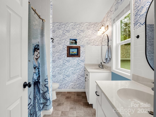 725 Center St, Asheville, NC 28803 - full bathroom with wallpapered walls, toilet, two vanities, a shower with shower curtain, and baseboards