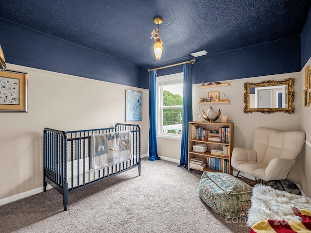 725 Center St, Asheville, NC 28803 - carpeted bedroom featuring baseboards, a crib, and a textured ceiling