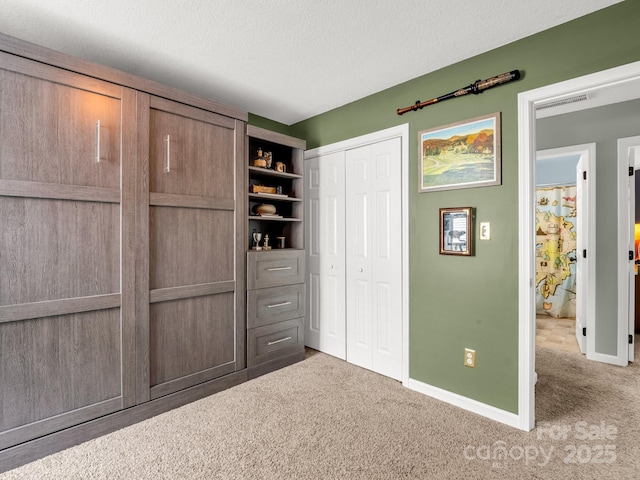 725 Center St, Asheville, NC 28803 - unfurnished bedroom with carpet, baseboards, a closet, and a textured ceiling