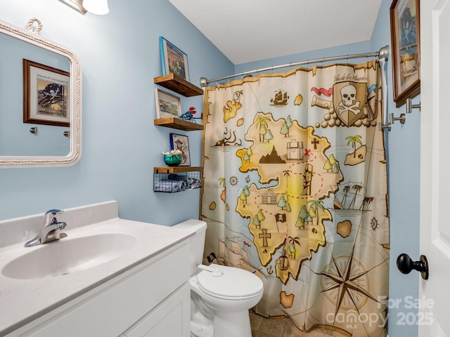 725 Center St, Asheville, NC 28803 - full bathroom with vanity, toilet, curtained shower, and tile patterned flooring