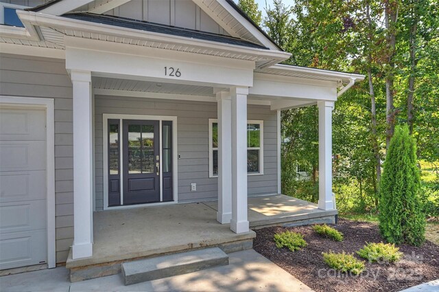 126 Meadow Glen Dr, Troutman, NC 28166 - view of exterior entry featuring covered porch and board and batten siding