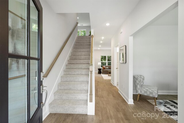 126 Meadow Glen Dr, Troutman, NC 28166 - staircase featuring plenty of natural light, wood finished floors, baseboards, and recessed lighting