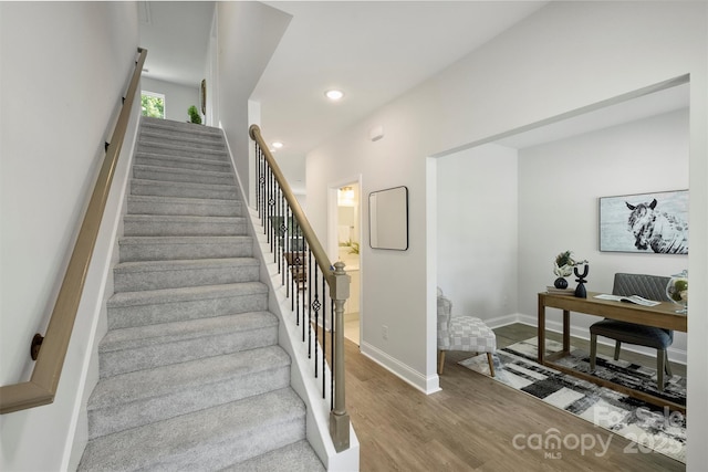 126 Meadow Glen Dr, Troutman, NC 28166 - stairway with wood finished floors, baseboards, and recessed lighting