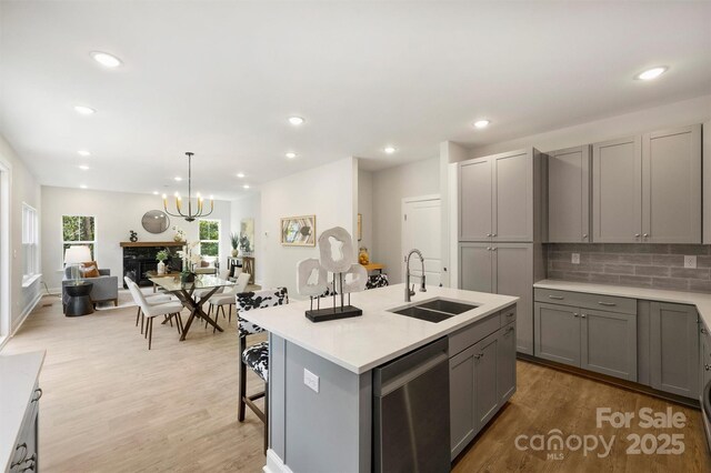 126 Meadow Glen Dr, Troutman, NC 28166 - kitchen with a sink, gray cabinets, dishwasher, tasteful backsplash, and light countertops