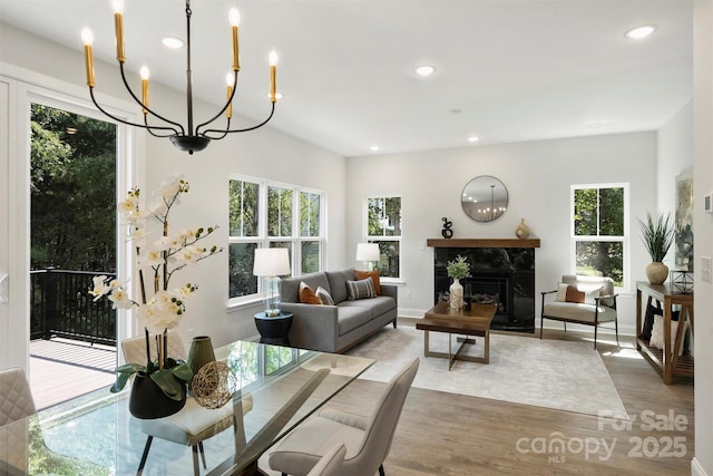 126 Meadow Glen Dr, Troutman, NC 28166 - dining area with a chandelier, recessed lighting, wood finished floors, a premium fireplace, and baseboards