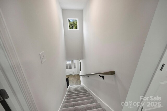 126 Meadow Glen Dr, Troutman, NC 28166 - stairs with plenty of natural light, baseboards, and wood finished floors