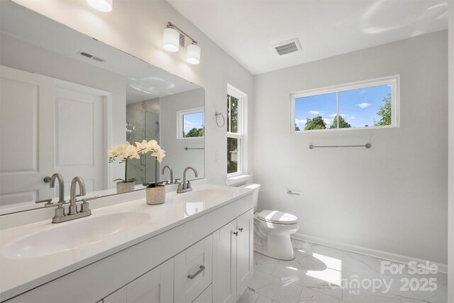 126 Meadow Glen Dr, Troutman, NC 28166 - bathroom featuring double vanity, marble finish flooring, toilet, a stall shower, and baseboards