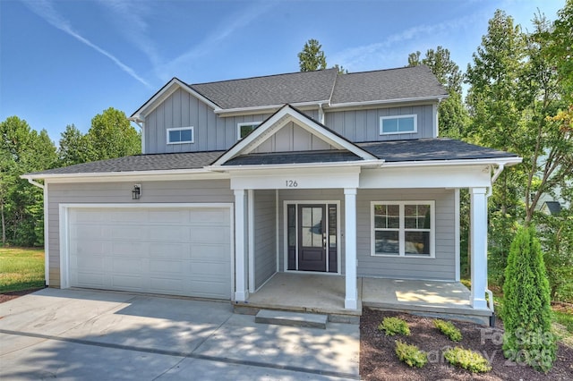 126 Meadow Glen Dr, Troutman, NC 28166 - view of front of home featuring covered porch, board and batten siding, concrete driveway, and an attached garage