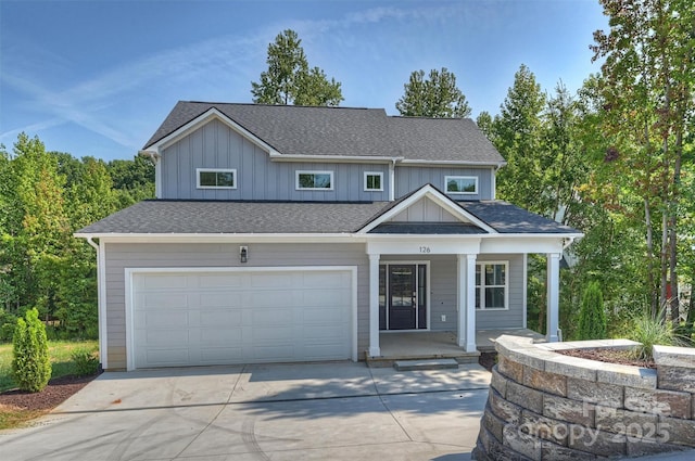 126 Meadow Glen Dr, Troutman, NC 28166 - view of front of property featuring a porch, driveway, a garage, board and batten siding, and roof with shingles