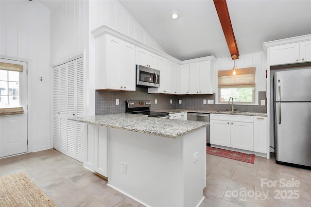 5929 Brookhaven Rd, Charlotte, NC 28210 - kitchen featuring appliances with stainless steel finishes, a sink, decorative backsplash, a peninsula, and light stone counters