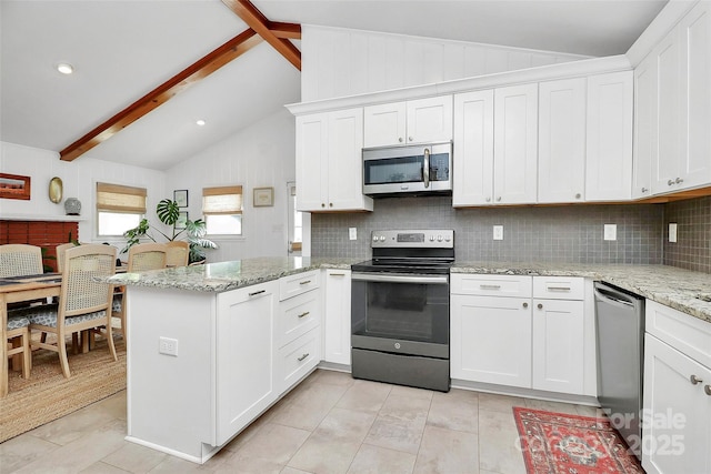 5929 Brookhaven Rd, Charlotte, NC 28210 - kitchen with appliances with stainless steel finishes, a peninsula, tasteful backsplash, and white cabinets