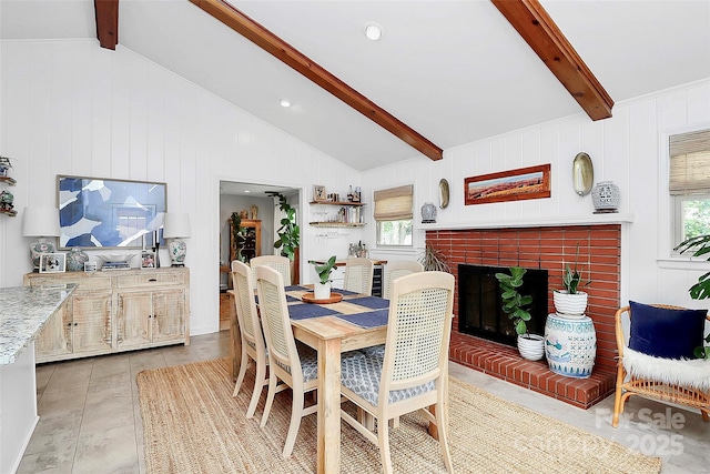 5929 Brookhaven Rd, Charlotte, NC 28210 - dining space with healthy amount of natural light, a brick fireplace, light tile patterned flooring, and wood walls