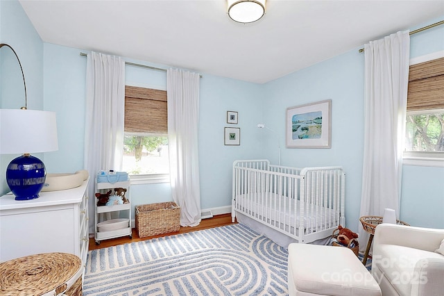 5929 Brookhaven Rd, Charlotte, NC 28210 - bedroom featuring wood finished floors and a crib