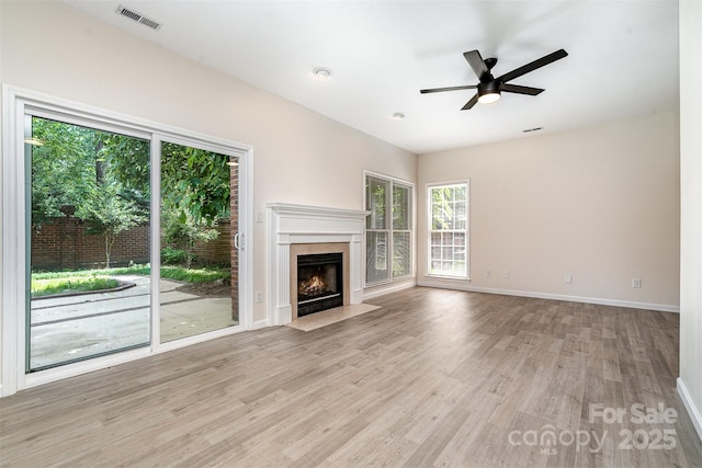 7031 Walton Heath Ln, Charlotte, NC 28277 - unfurnished living room with wood finished floors, baseboards, a fireplace, and a ceiling fan