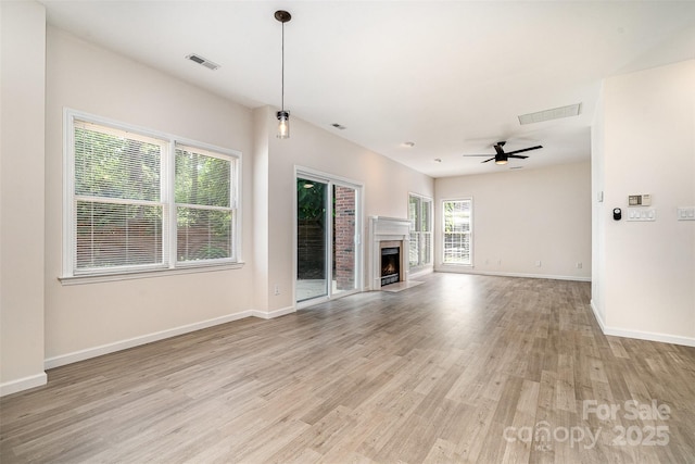 7031 Walton Heath Ln, Charlotte, NC 28277 - unfurnished living room featuring light wood-style flooring, ceiling fan, baseboards, and a fireplace with flush hearth