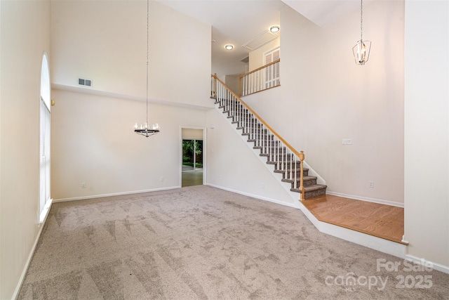 7031 Walton Heath Ln, Charlotte, NC 28277 - unfurnished living room featuring a chandelier, a towering ceiling, carpet flooring, stairway, and baseboards