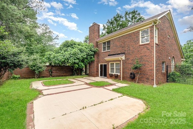 7031 Walton Heath Ln, Charlotte, NC 28277 - back of property with a patio, a chimney, and brick siding