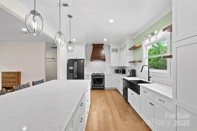 94 Jamestown Ln, Columbus, NC 28722 - kitchen featuring stainless steel appliances, a sink, custom range hood, crown molding, and open shelves