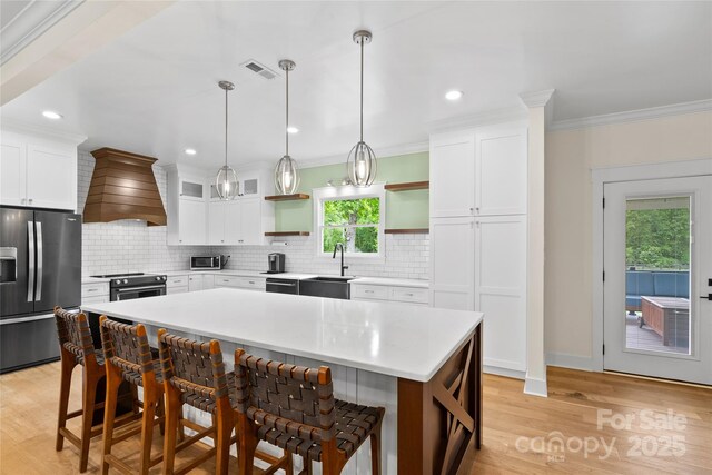 94 Jamestown Ln, Columbus, NC 28722 - kitchen with appliances with stainless steel finishes, open shelves, wall chimney exhaust hood, a sink, and a kitchen bar