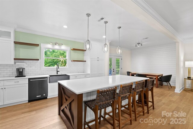 94 Jamestown Ln, Columbus, NC 28722 - kitchen with open shelves, dishwashing machine, a sink, crown molding, and a kitchen bar