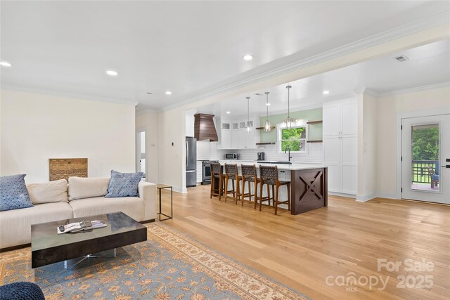 94 Jamestown Ln, Columbus, NC 28722 - living area with light wood-style flooring, recessed lighting, ornamental molding, and baseboards