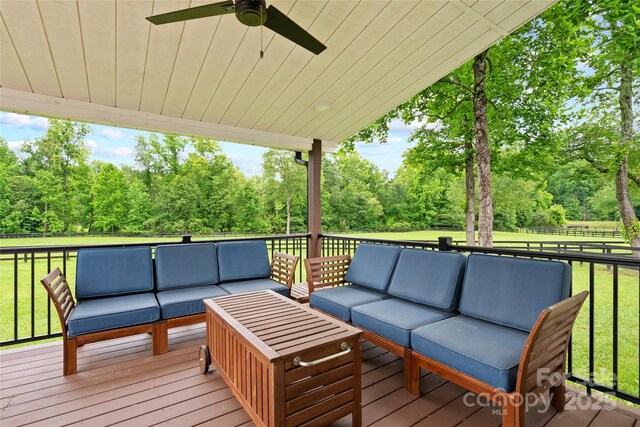 94 Jamestown Ln, Columbus, NC 28722 - wooden deck with outdoor lounge area, ceiling fan, and view of wooded area