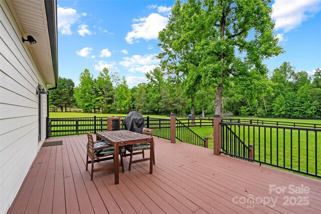 94 Jamestown Ln, Columbus, NC 28722 - wooden terrace featuring a lawn, outdoor dining area, view of wooded area, and area for grilling