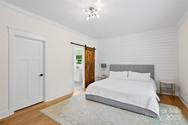 94 Jamestown Ln, Columbus, NC 28722 - bedroom featuring a barn door, wood finished floors, ornamental molding, a chandelier, and a sink
