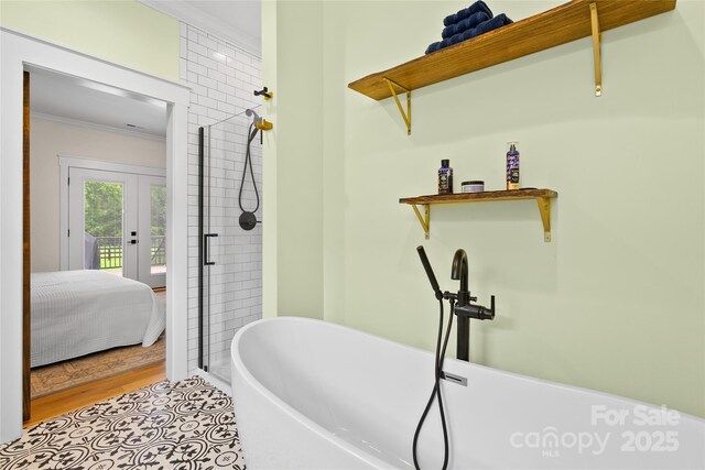 94 Jamestown Ln, Columbus, NC 28722 - ensuite bathroom with ornamental molding, a soaking tub, a shower stall, and wood finished floors