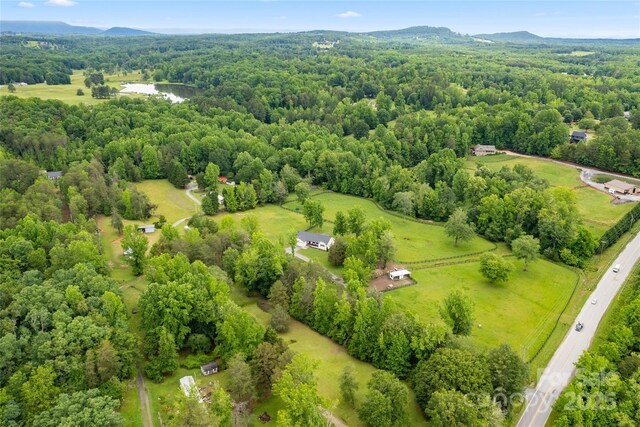 94 Jamestown Ln, Columbus, NC 28722 - bird's eye view of a heavily wooded area and a mountainous background