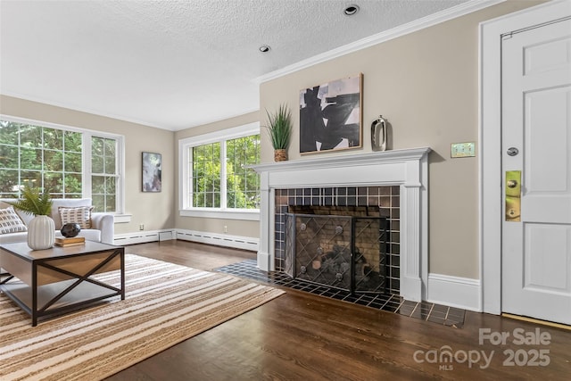 121 33rd Ave NE, Hickory, NC 28601 - living room with wood finished floors, a tile fireplace, a textured ceiling, crown molding, and baseboards