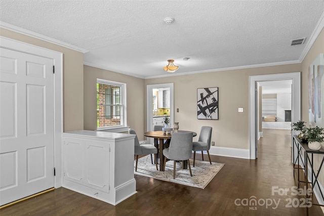 121 33rd Ave NE, Hickory, NC 28601 - dining space with dark wood-style floors, a textured ceiling, crown molding, and baseboards