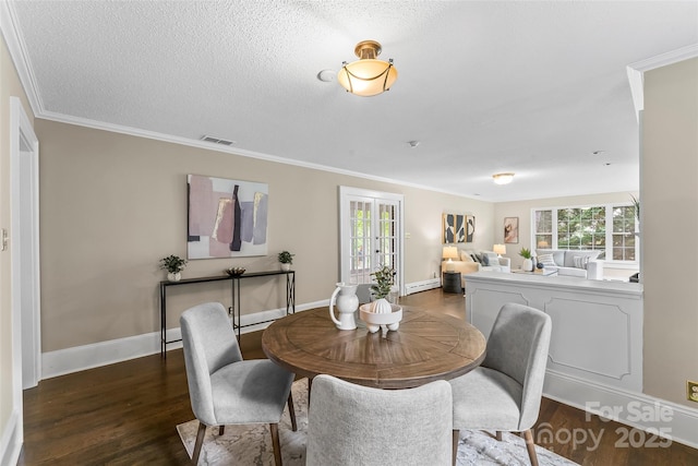 121 33rd Ave NE, Hickory, NC 28601 - dining room featuring plenty of natural light, dark wood finished floors, crown molding, and baseboards