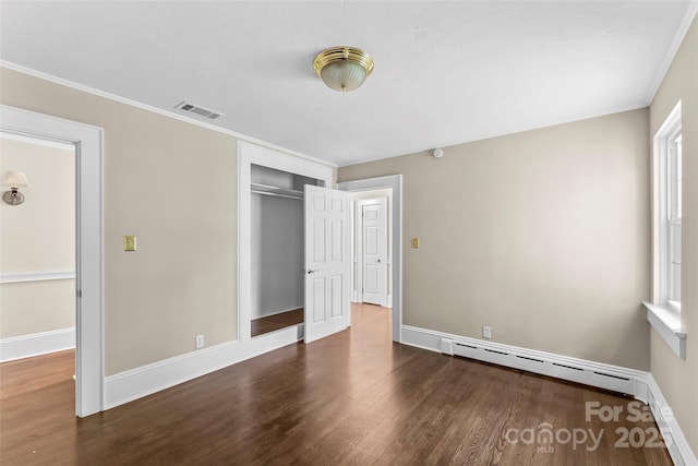 121 33rd Ave NE, Hickory, NC 28601 - unfurnished bedroom featuring a baseboard radiator, wood finished floors, baseboards, a closet, and ornamental molding