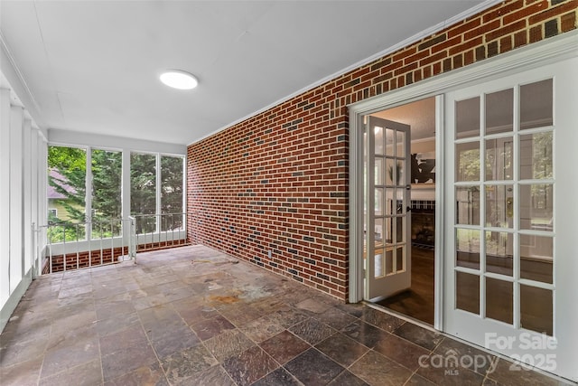 121 33rd Ave NE, Hickory, NC 28601 - unfurnished sunroom with brick wall and stone finish flooring