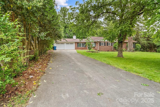 121 33rd Ave NE, Hickory, NC 28601 - single story home featuring asphalt driveway, a garage, a front yard, brick siding, and a chimney