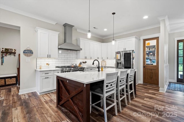 867 Bellegray Rd, Clover, SC 29710 - kitchen featuring wall chimney range hood, stainless steel fridge with ice dispenser, dark wood-style floors, light countertops, and backsplash