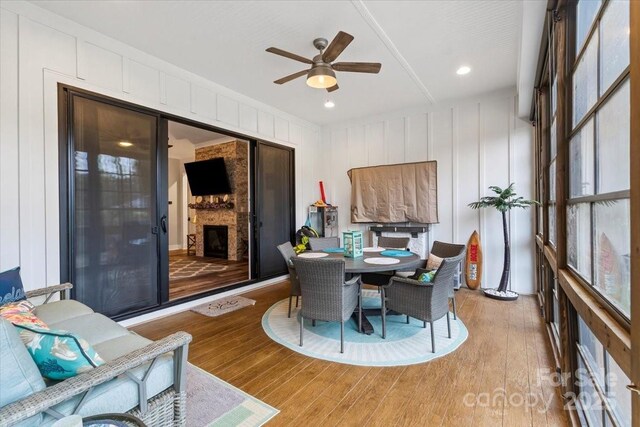 867 Bellegray Rd, Clover, SC 29710 - dining area featuring light wood-style flooring, a ceiling fan, and a large fireplace
