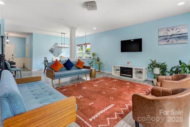 1017 Quail Run Ct, Indian Land, SC 29707 - living area with wood finished floors, recessed lighting, a wainscoted wall, and a chandelier